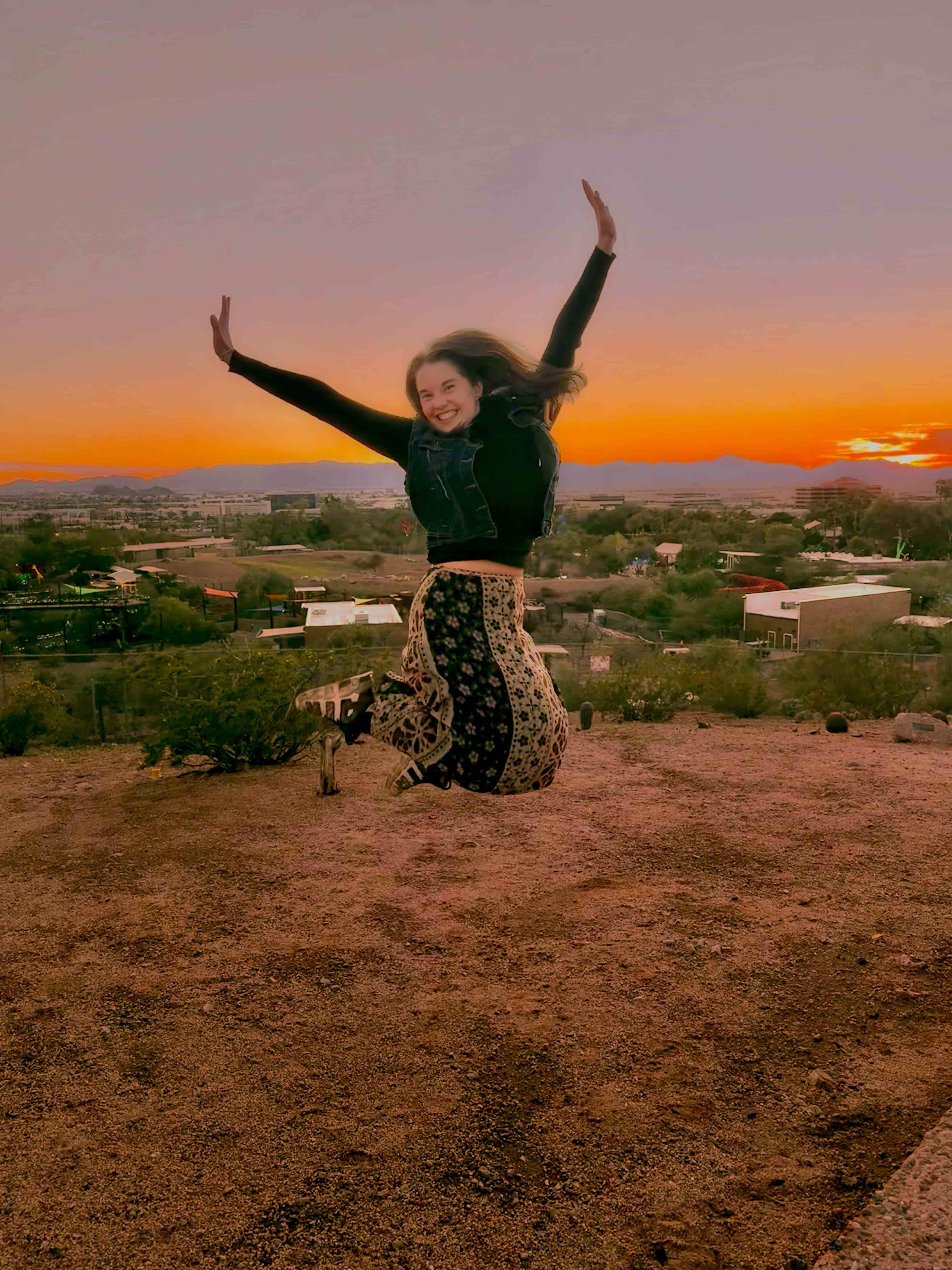 Janis Rogers, Founder of Unbound, dancing freely at sunset